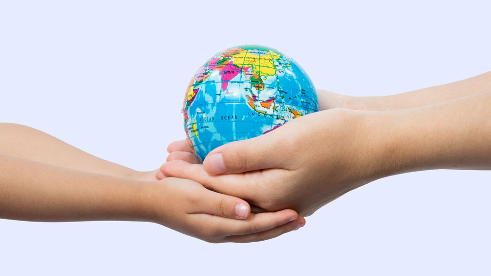 two hands holding a globe