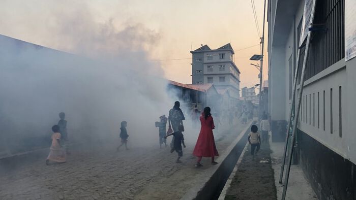 The picture shows people covered by the fumes of mosquito repellent in the refugee camp on the island of Bhasan Char