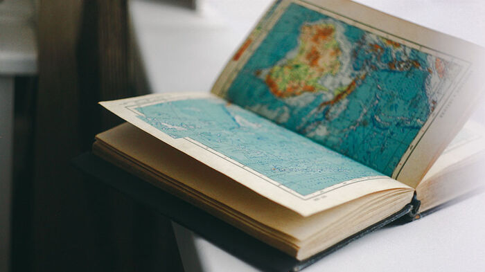 An open book with a world map inside. 