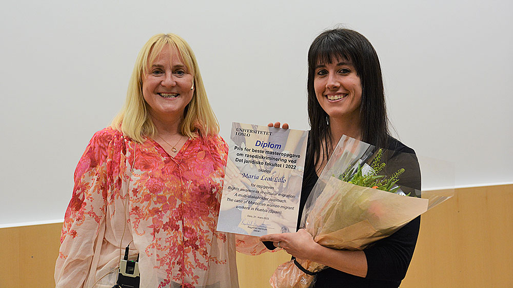 Maria Leal Lillo and Committee Chair. Lillo holds a diploma and a bouquet of flowers